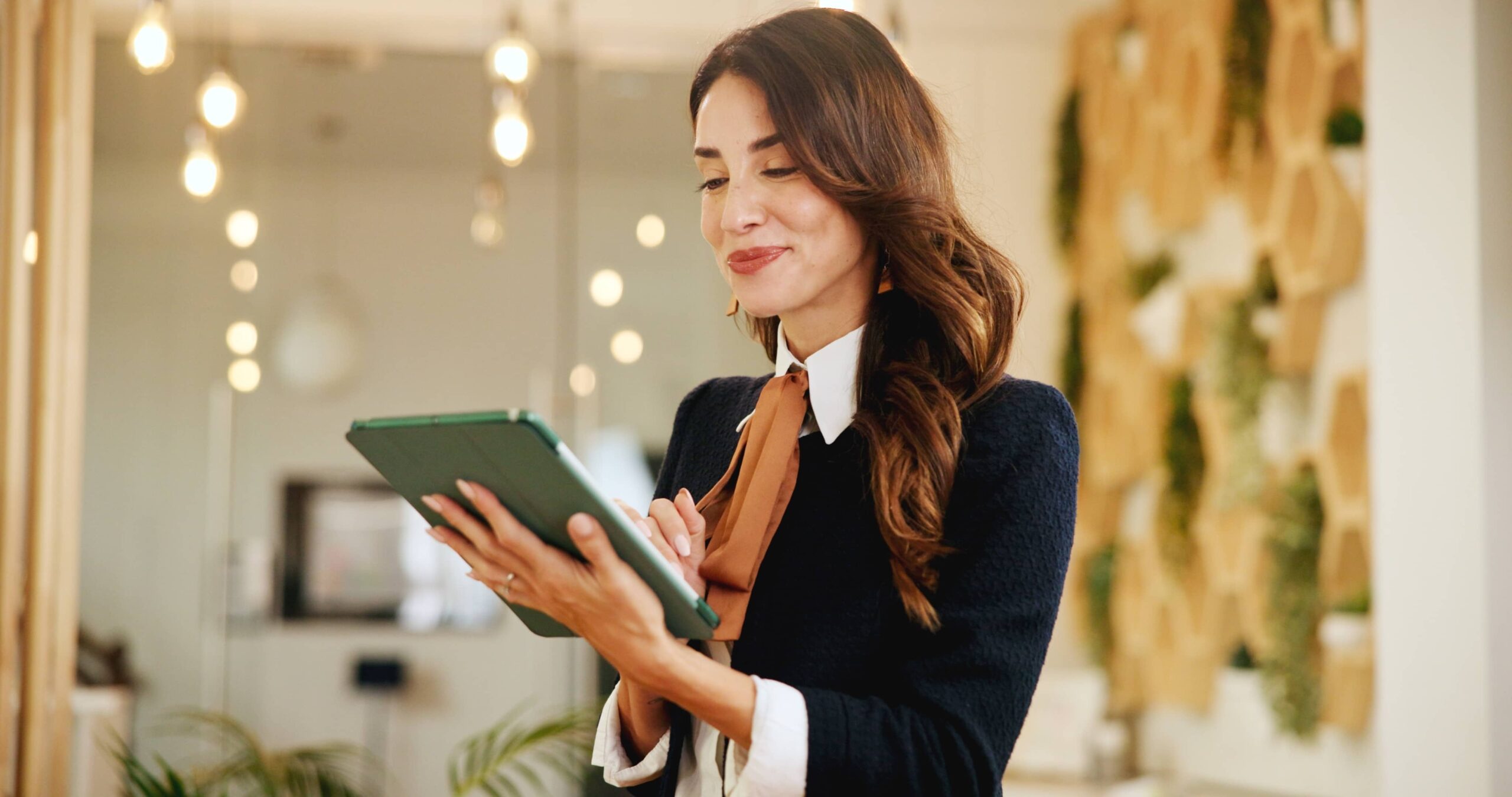 woman in hospitality scheduling events on ipad