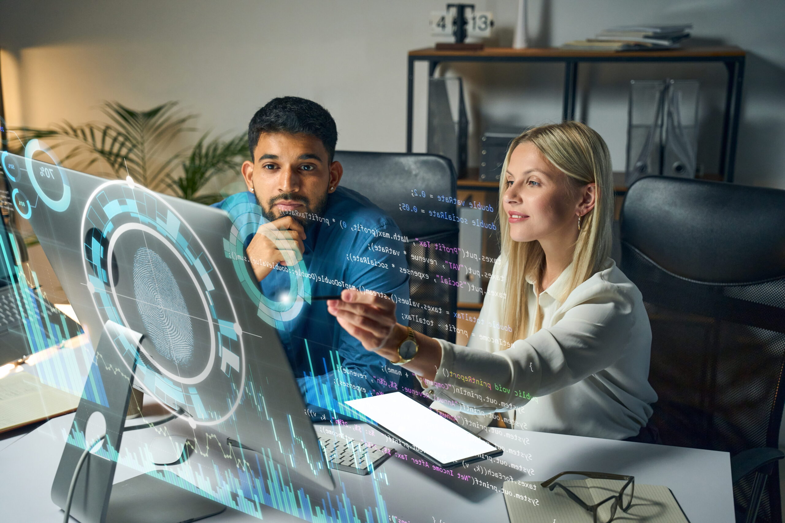 two co-workers looking at computer screen