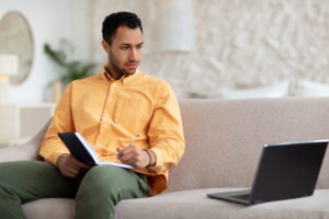 adult male taking online classes from home