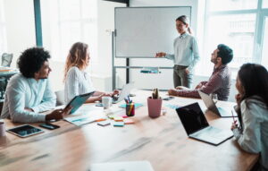 marketing professional presenting brand concept on white board